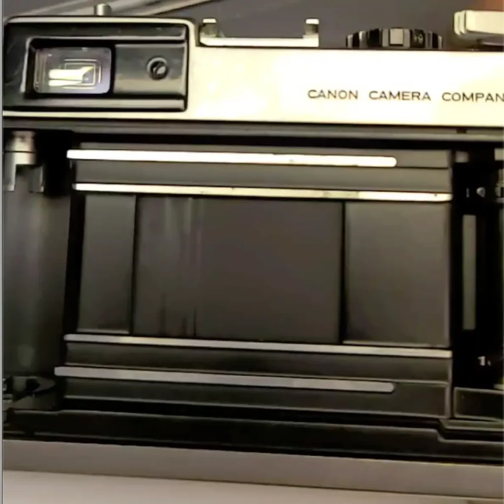 Close up of the back of a Canon film camera opened to show the shutter.